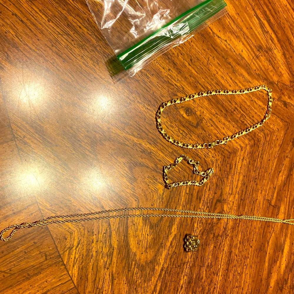 One long chain, a necklace and bracelet and a USA pin.